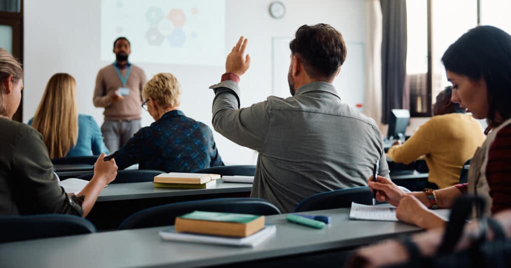 HVAC brands presentation with student raising hand and instructor speaking