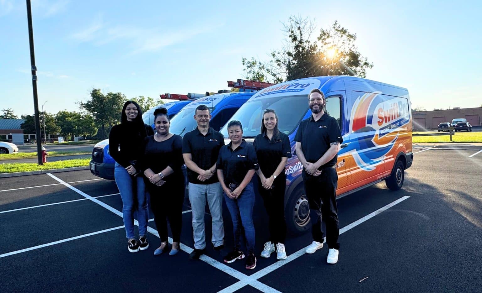 The SwiftPro office team with owner Tyler Griffin in front of a wrapped SwiftPro van in Chantilly, Northern Virginia