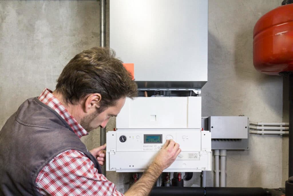 HVAC technician servicing heating system, annual heating maintenance checklist