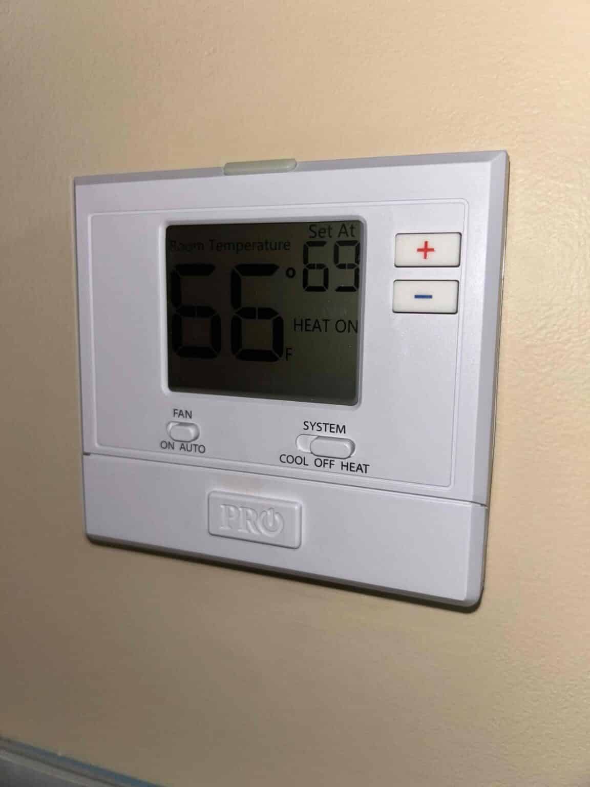 A wall thermostat in a Northern Virginia home set to 66 degrees in heating mode