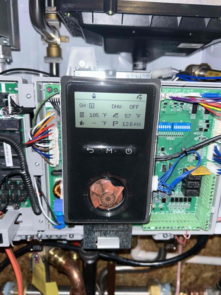 HVAC system components and digital display showing temperature and pressure readings, residential HVAC maintenance.