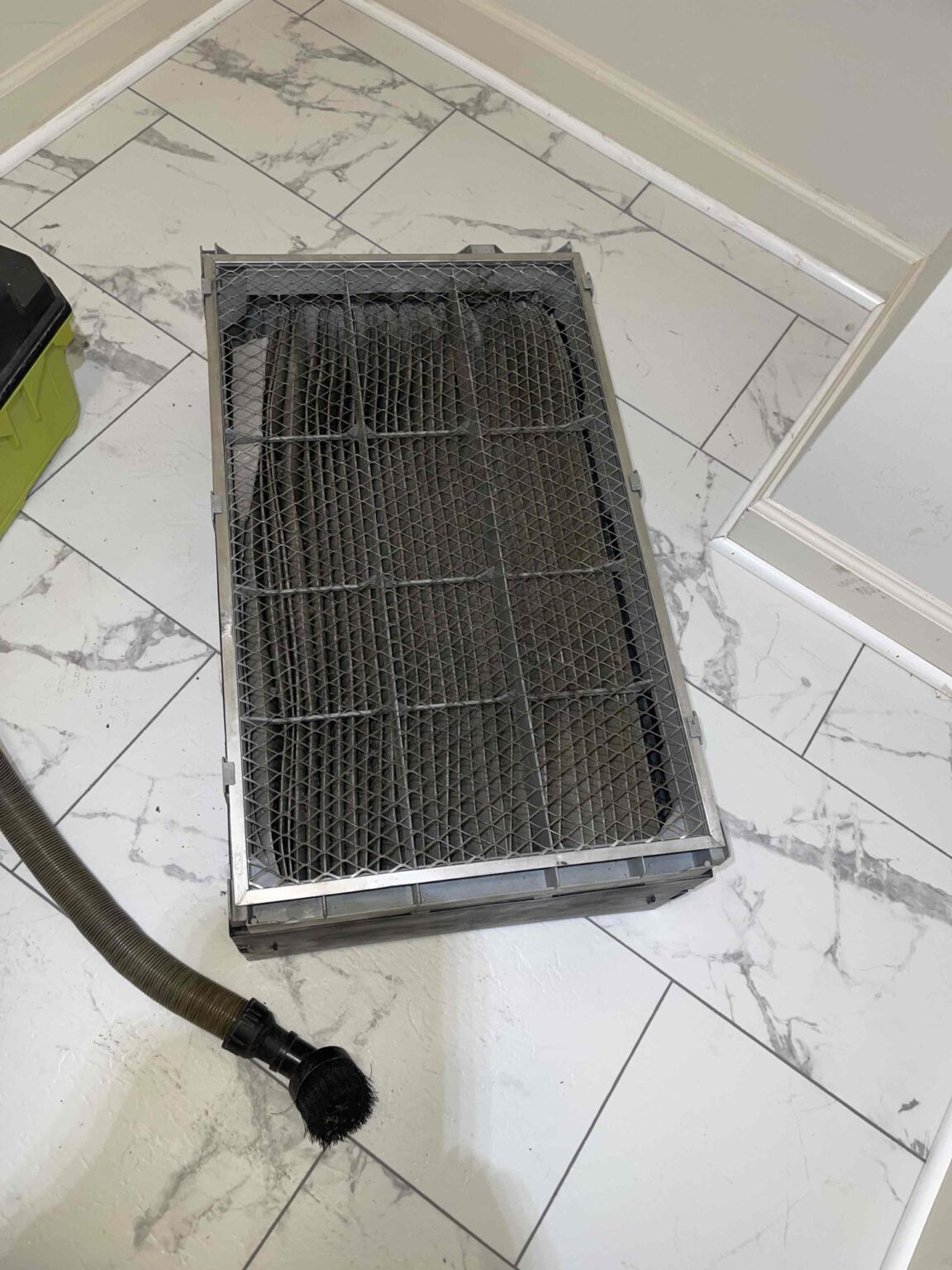 Dirty HVAC duct air filter needing replacement in Northern Virginia home.