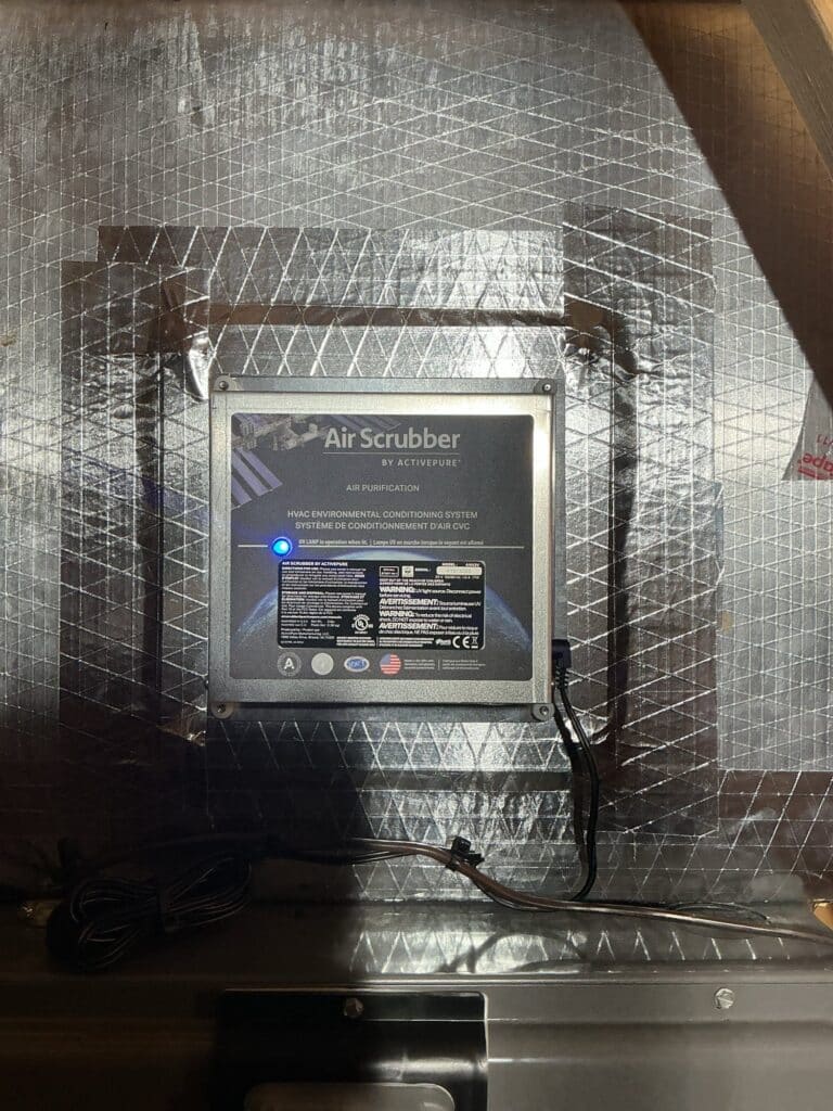 An ActivePure Air Scrubber installed in the supply ductwork of a Northern Virginia home, UV lamp lit.