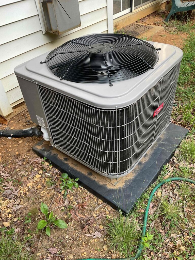 A clean outdoor air conditioning condenser beside a Northern Virginia home after service