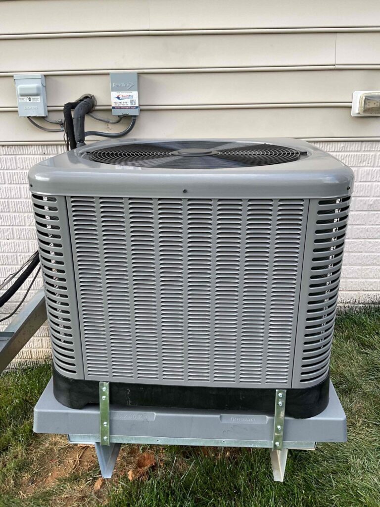 A large two-fan condensing unit mounted on wall brackets at a Northern Virginia home