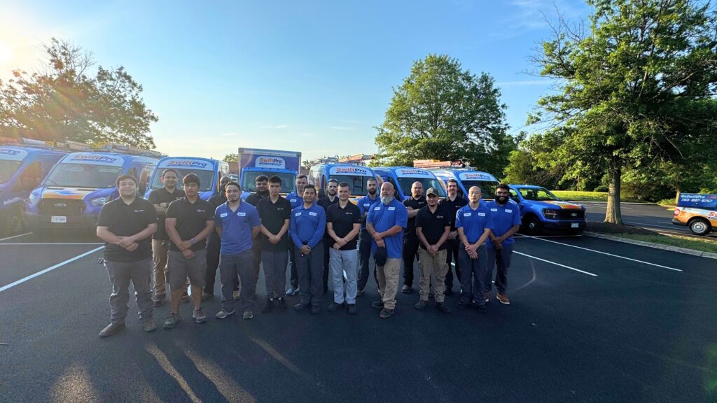 The SwiftPro team standing in front of their service vans in Northern Virginia.