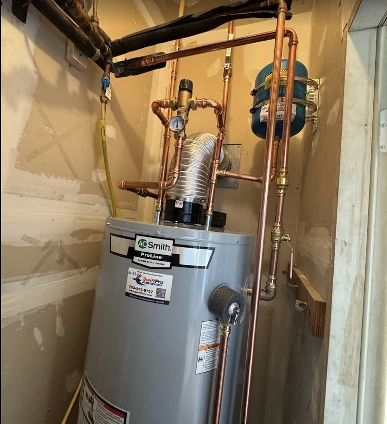 An A.O. Smith tank water heater installed by SwiftPro with copper supply lines and a shutoff valve