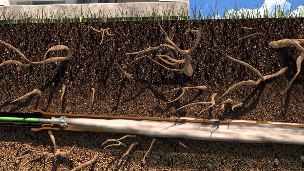Cutaway illustration of a high-pressure water jetter washing cut roots and debris out of a buried sewer lateral so a cured-in-place liner can bond to the pipe wall