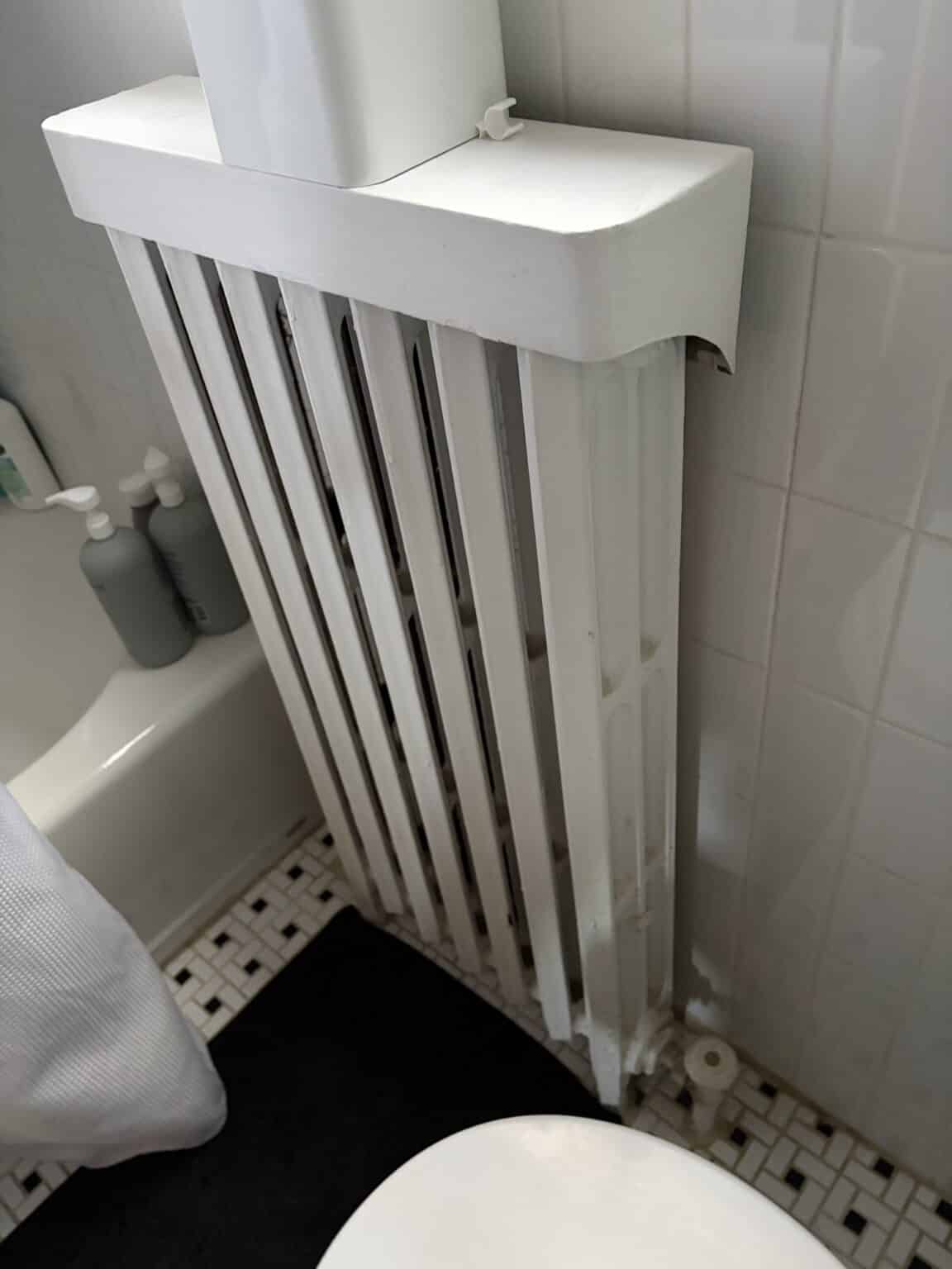 A painted cast iron radiator in a Northern Virginia home, the heat emitter on a hydronic boiler system
