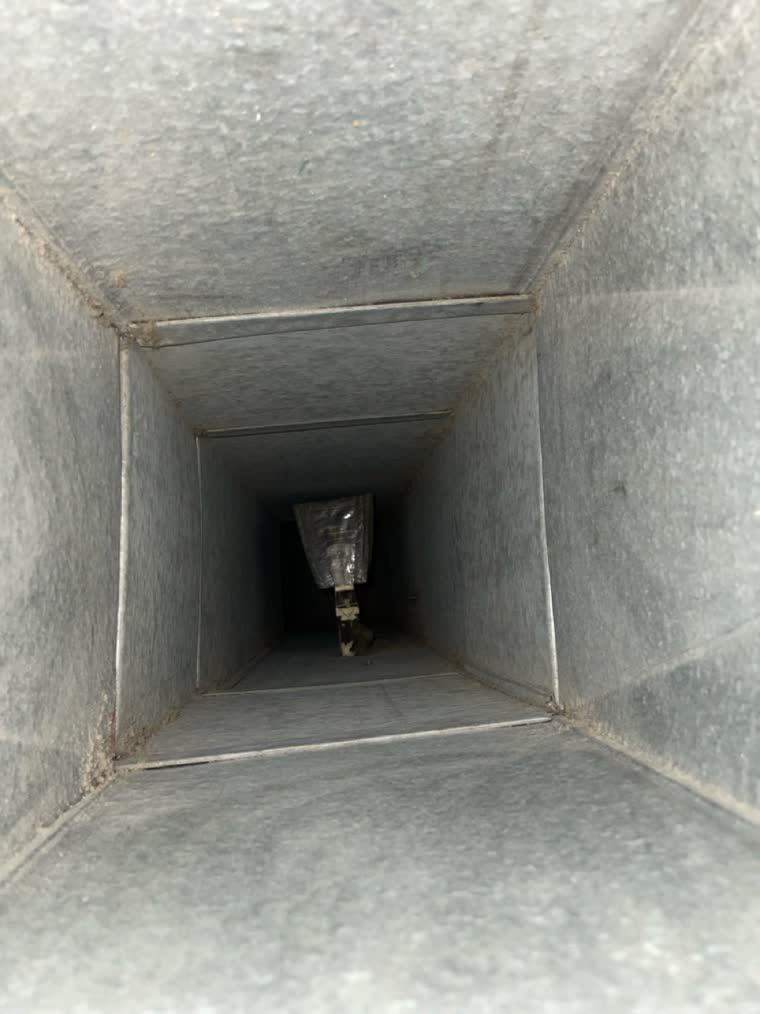 The same branch takeoff in the same Northern Virginia supply duct after SwiftPro cleaned it, the opening clear