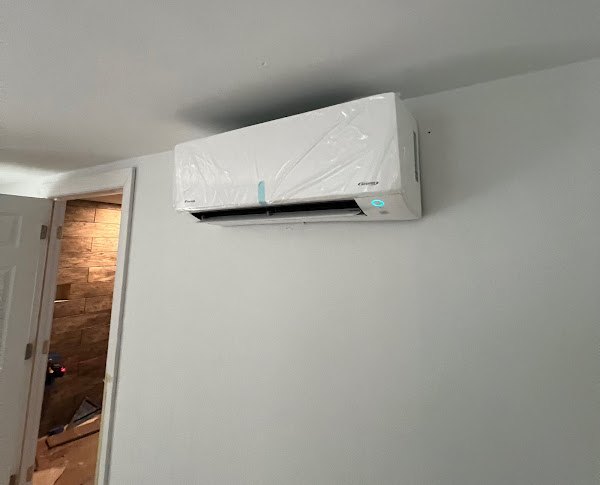 A newly installed ductless mini split head still in its protective wrap on the wall of a Northern Virginia home.