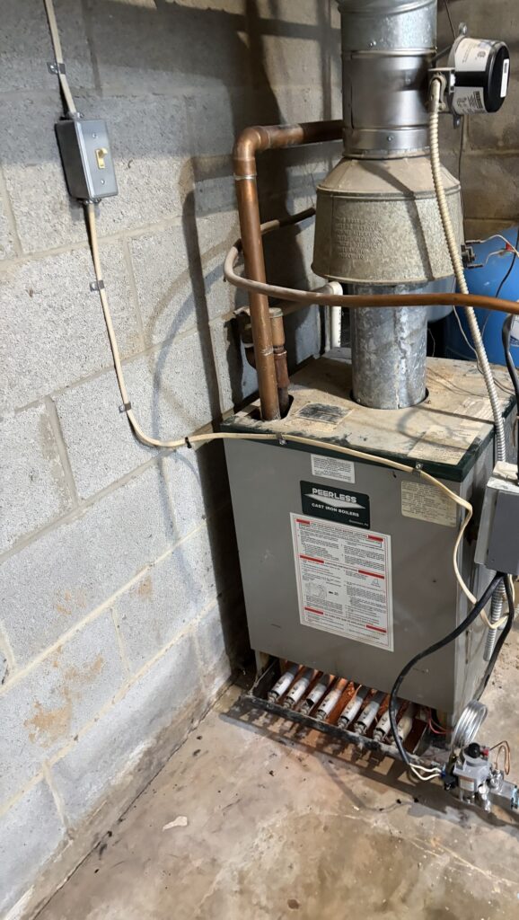 An aging Peerless cast iron boiler in a Northern Virginia basement, chimney vented, on a SwiftPro service call