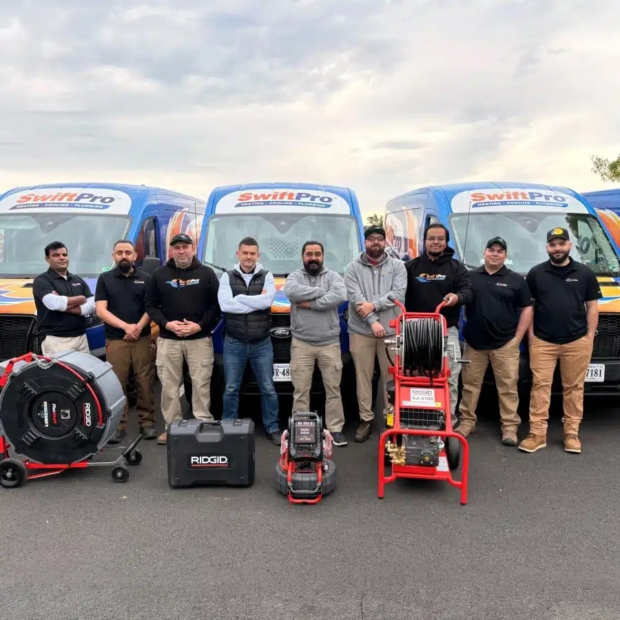 The SwiftPro plumbing team in front of three wrapped SwiftPro vans in Northern Virginia, with their RIDGID FlexShaft drain machine, SeeSnake sewer camera and KJ-3100 water jetter