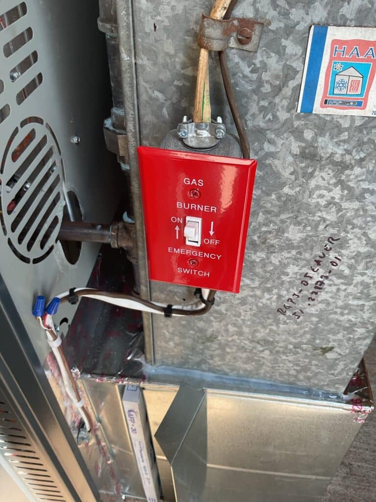 A pressure test gauge connected by SwiftPro to the water supply beside a water heater in a Northern Virginia home