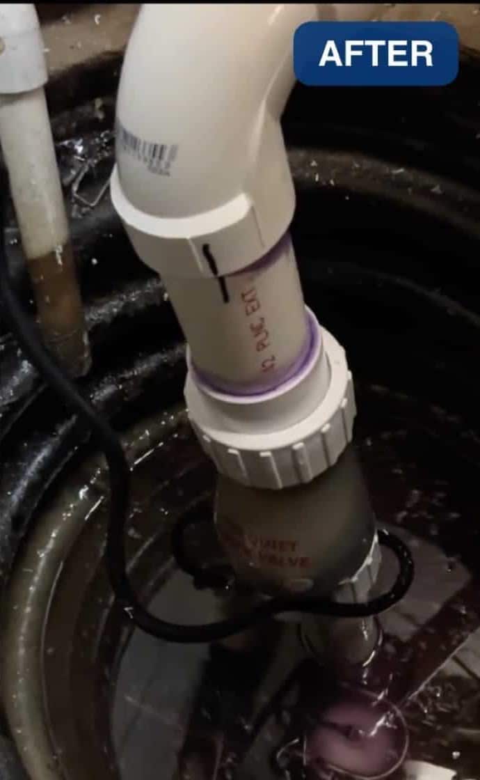 A new quiet check valve on the white discharge pipe of a sump pump in a Northern Virginia basement pit
