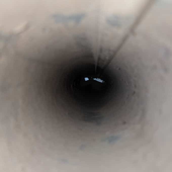 The same dryer vent line after SwiftPro cleaned it, bare metal all the way down, in Ashburn, Virginia