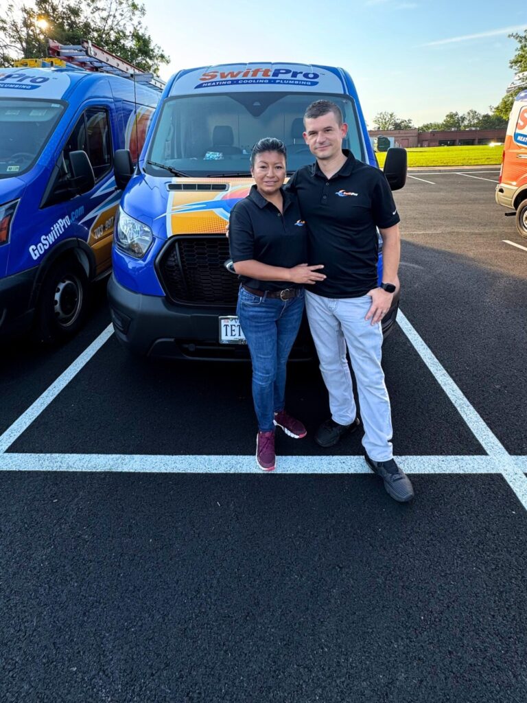 Two members of the SwiftPro team in front of a wrapped SwiftPro van in Northern Virginia