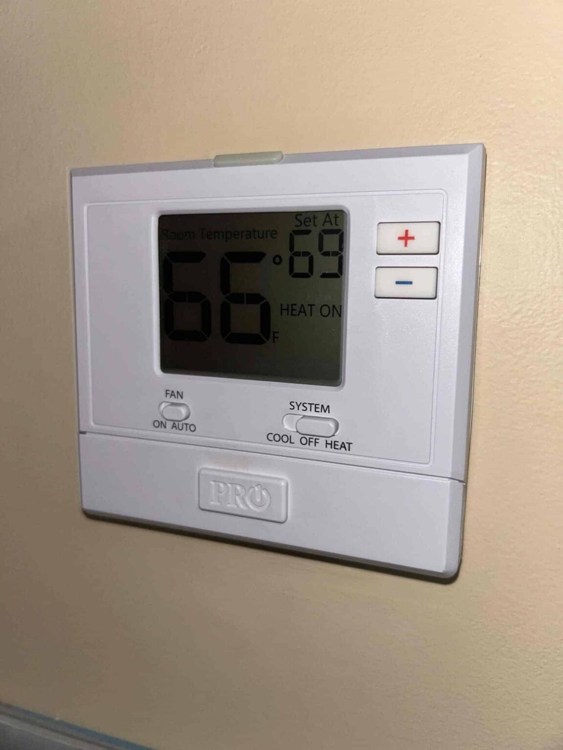 A thermostat in a Northern Virginia home reading 66 degrees with the heat set to 69 and the heat running
