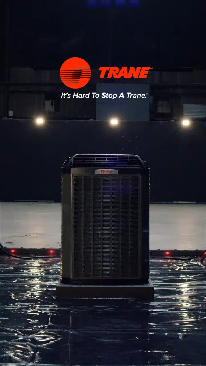 Trane's film: a Trane outdoor unit on a dark lab stage under the Trane logo and "It's Hard To Stop A Trane."