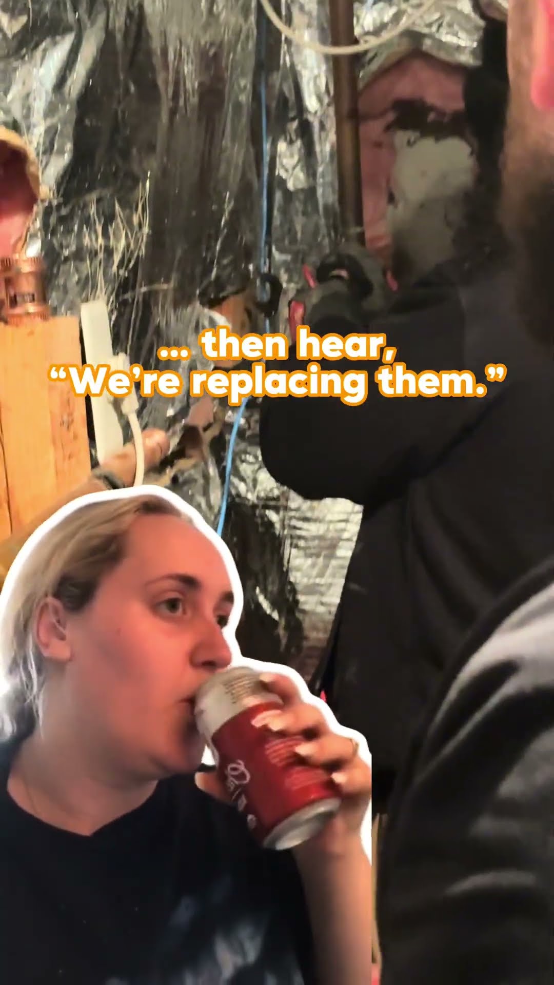 Kitchen skit: a woman drinks from a can as a sticker cutout while a tech works under the kitchen sink behind foil shielding.