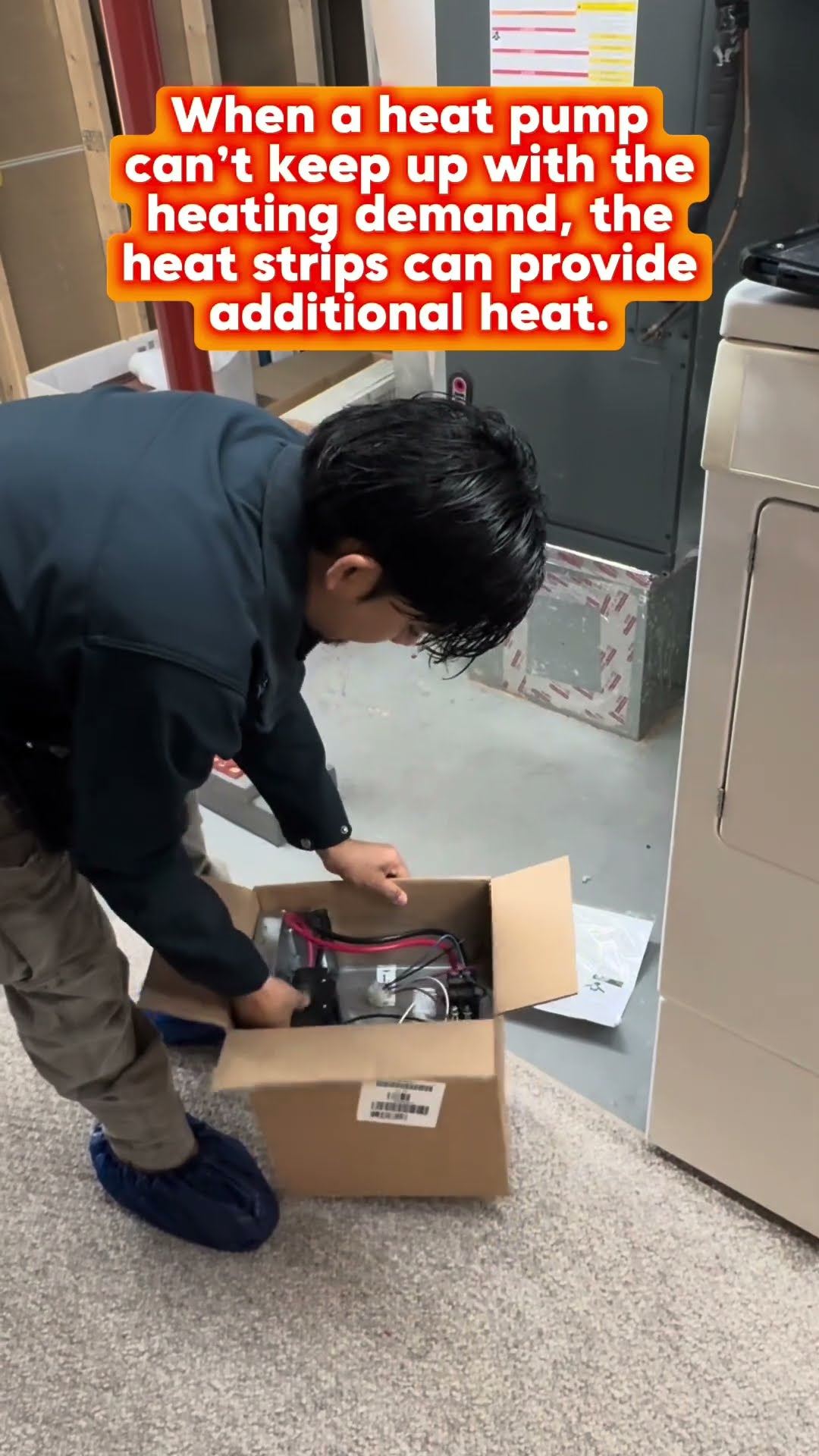Heat strip explainer: a young tech connects the condensate drain on an air handler in a utility room, unboxes an electric heat strip kit, and works in the open air handler cabinet.
