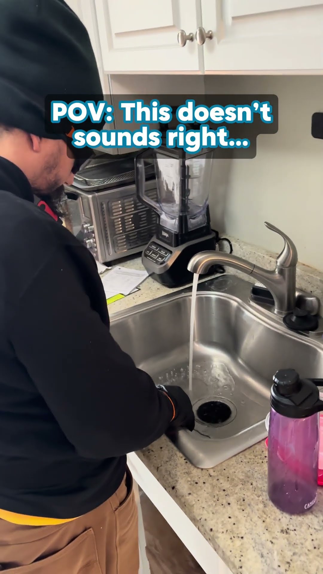 Skit about strange sounds: a tech in a black beanie runs water into a kitchen sink disposal, a tech in a gray cap digs out a buried sewer pipe and cleanout in a yard trench, and two techs work at an A